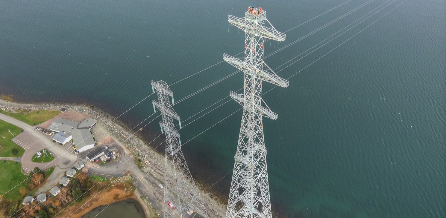 Aerial view of workers on top of a pylon
