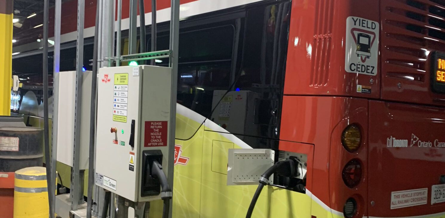 Electric bus connected to its charging station